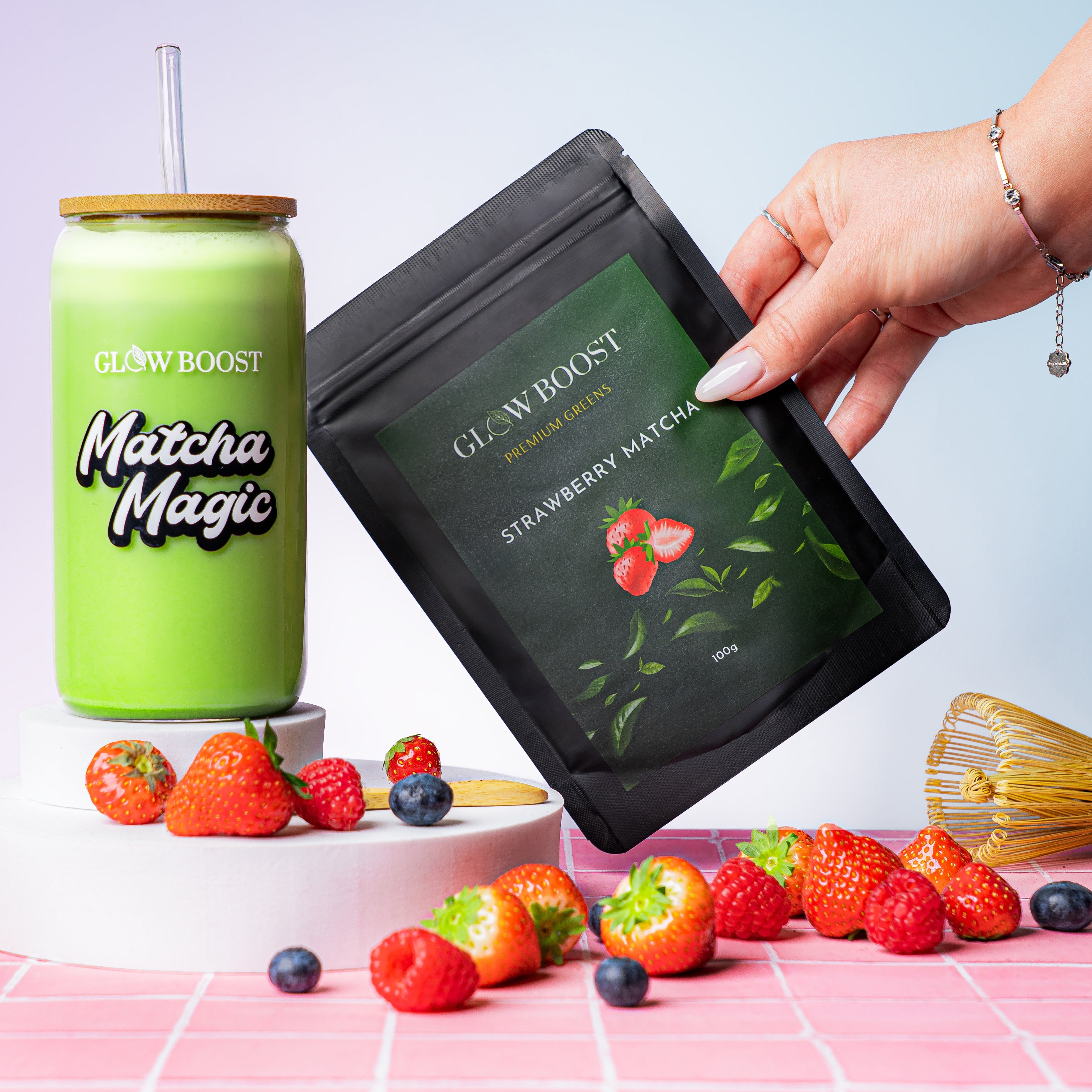 Matcha Magic product packaging with a green cup and strawberries on a pink surface